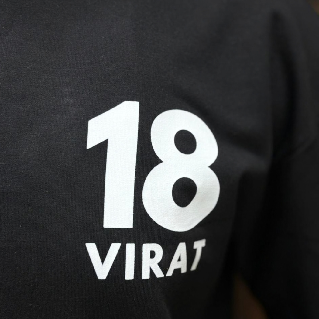 Virat Kohli RCB GOAT Era black oversized t-shirt front view  close up 18 virat  graphic print – Prospera Clothing