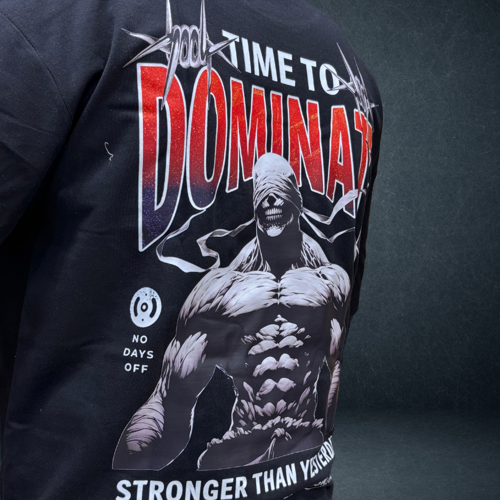 Side angle view of black DOMINATE oversized tee with bold warrior graphic - Prospera streetwear
