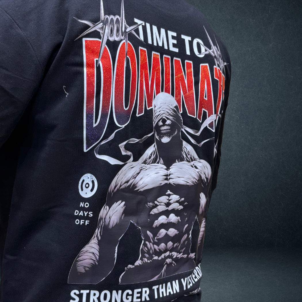 Side angle view of black DOMINATE oversized tee with bold warrior graphic - Prospera streetwear