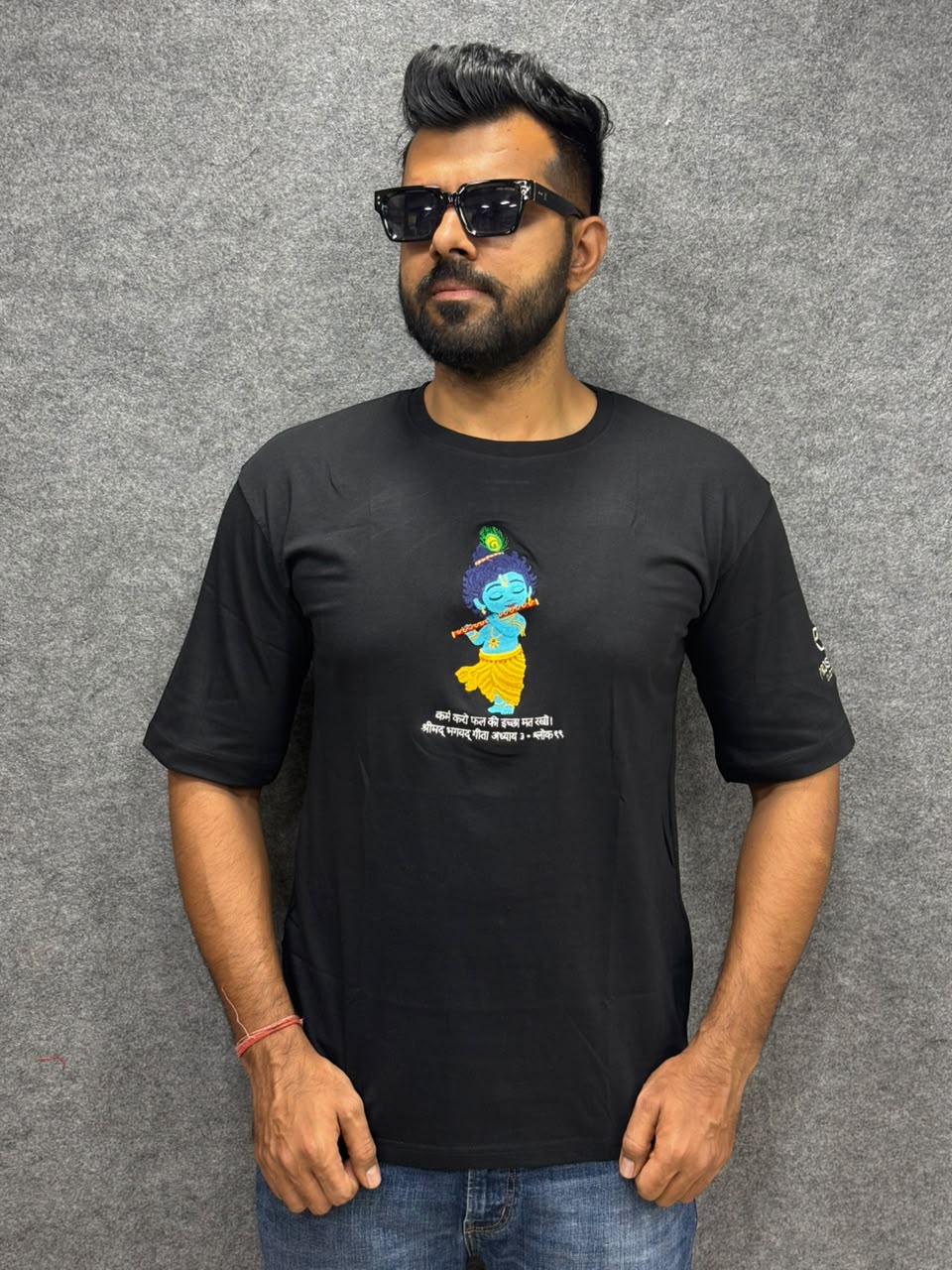 Model wear embroidery bal Krishna with flute and peacock feather on black cotton t-shirt with bagwadgita slok