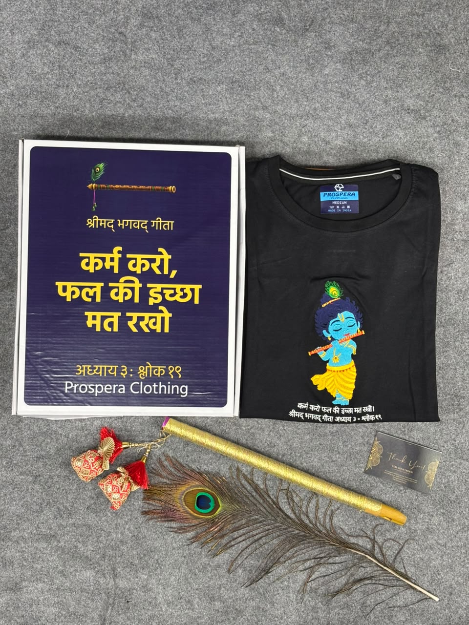 packaging of embroidery bal Krishna with flute and peacock feather on black cotton t-shirt with bagwadgita slok