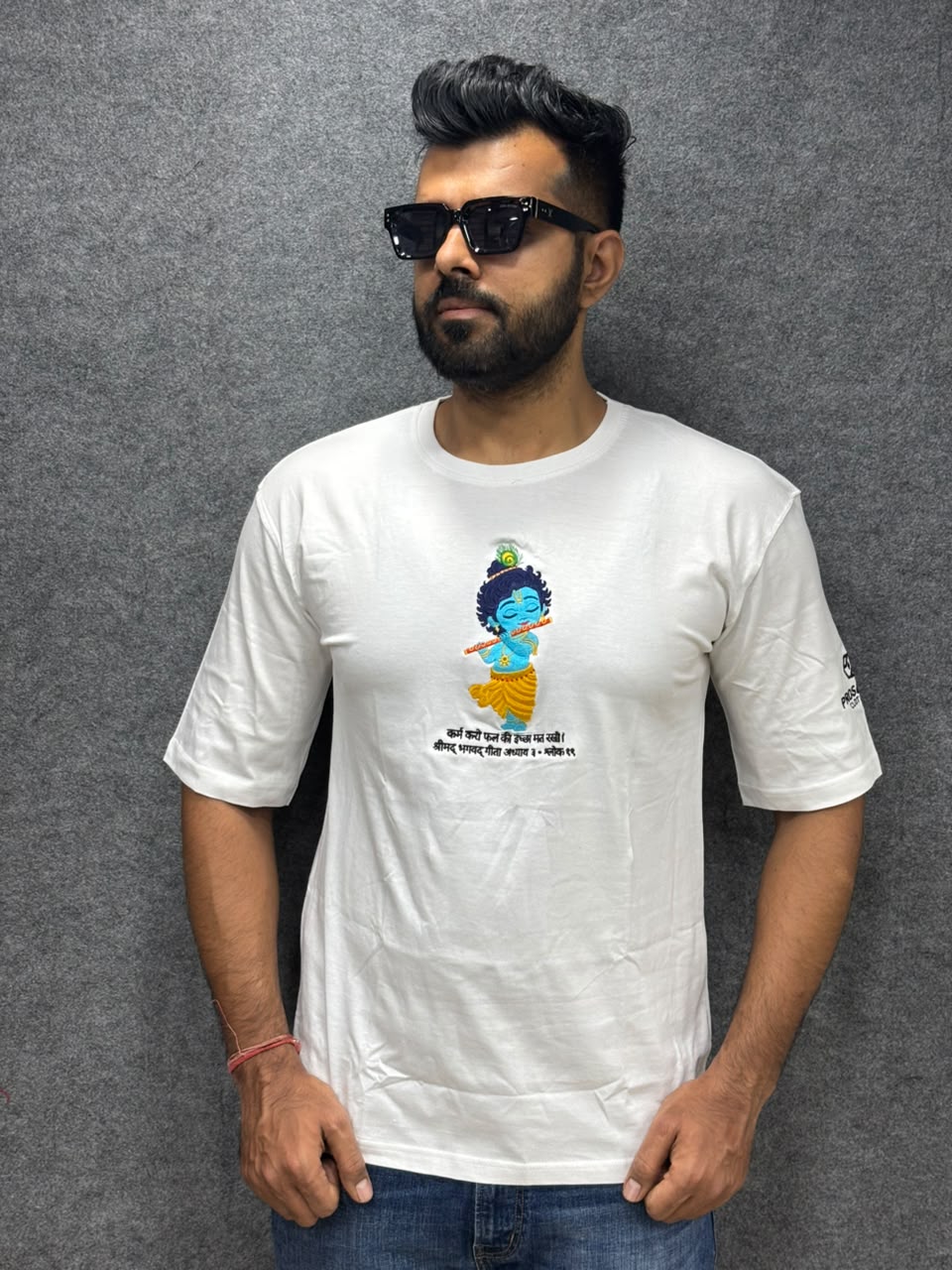 Model wear embroidery bal Krishna with flute and peacock feather on white cotton t-shirt with bagwadgita slok